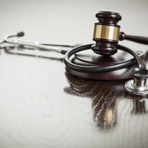 stethoscope and gavel on table
