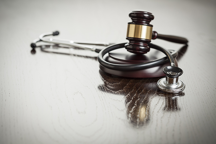 stethoscope and gavel on table