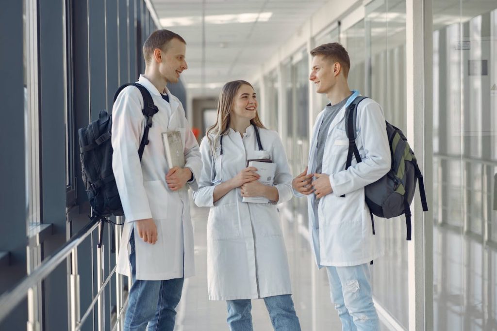 group of student nurses talking in hallway