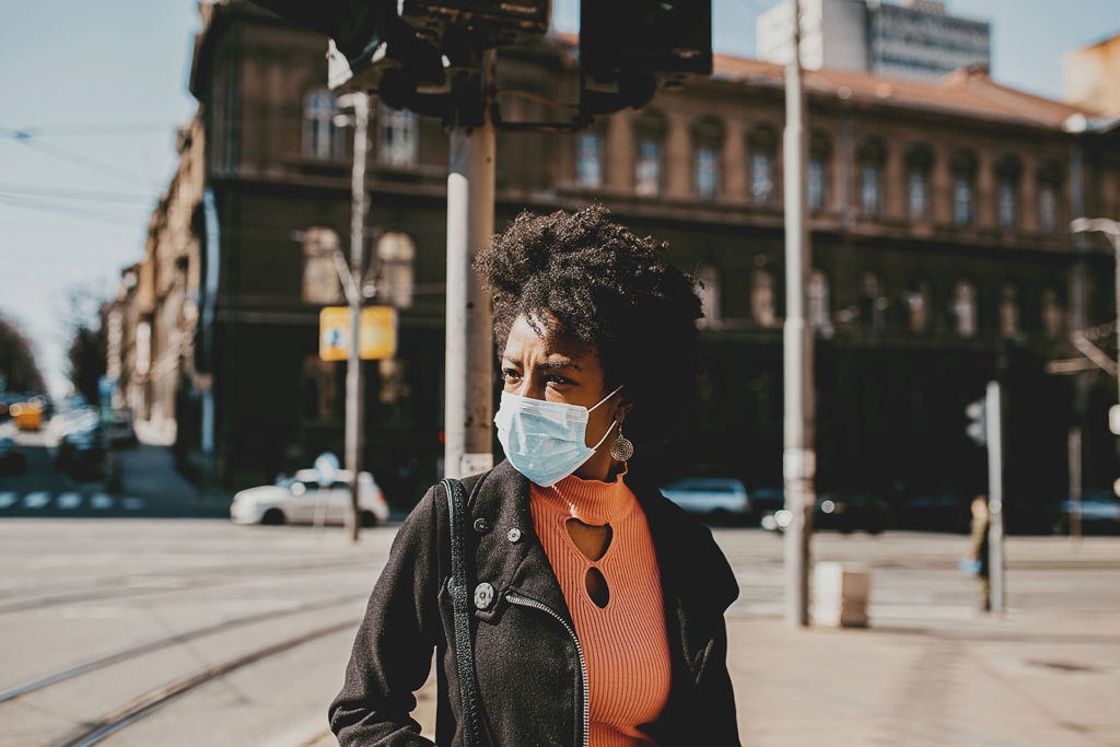 Black woman in city wearing face mask