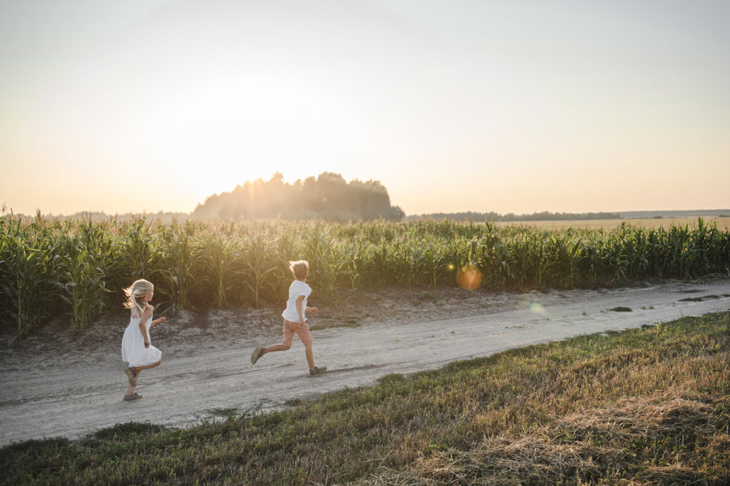 2 children running in a field