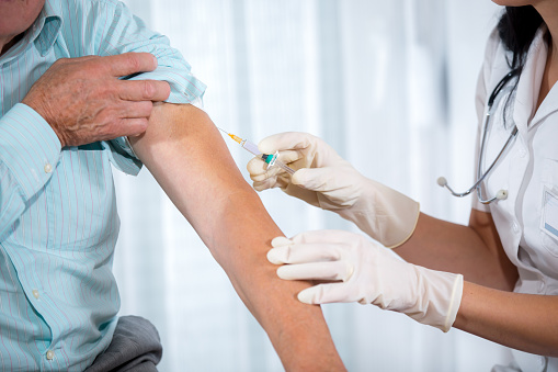 Provider giving a patient a vaccination