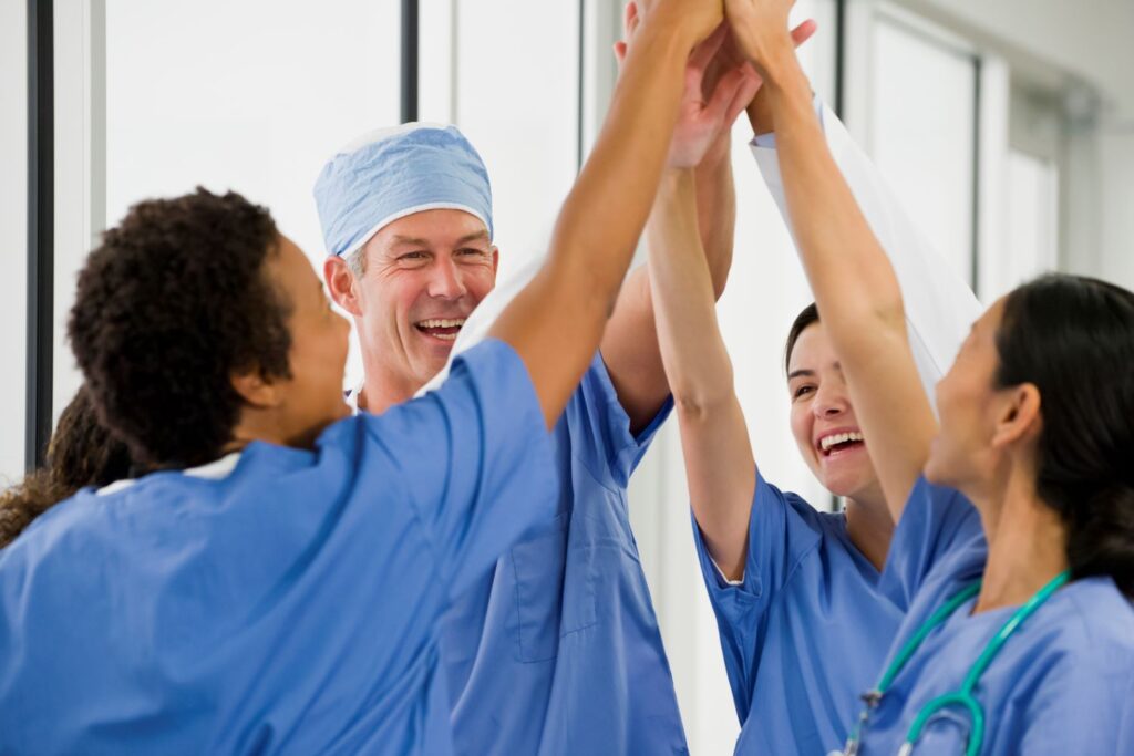 health care workers high fiving