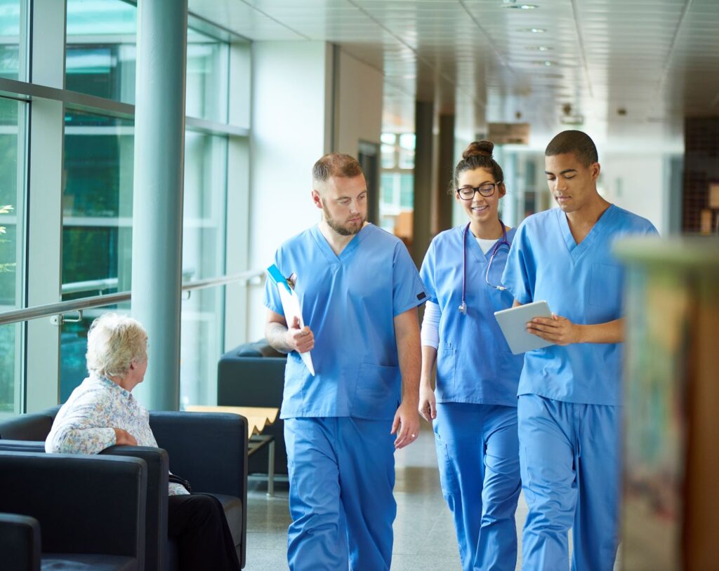 three health care workers walking and talking