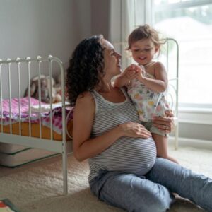 GettyImages 1415235701 mom,pregnant and infant